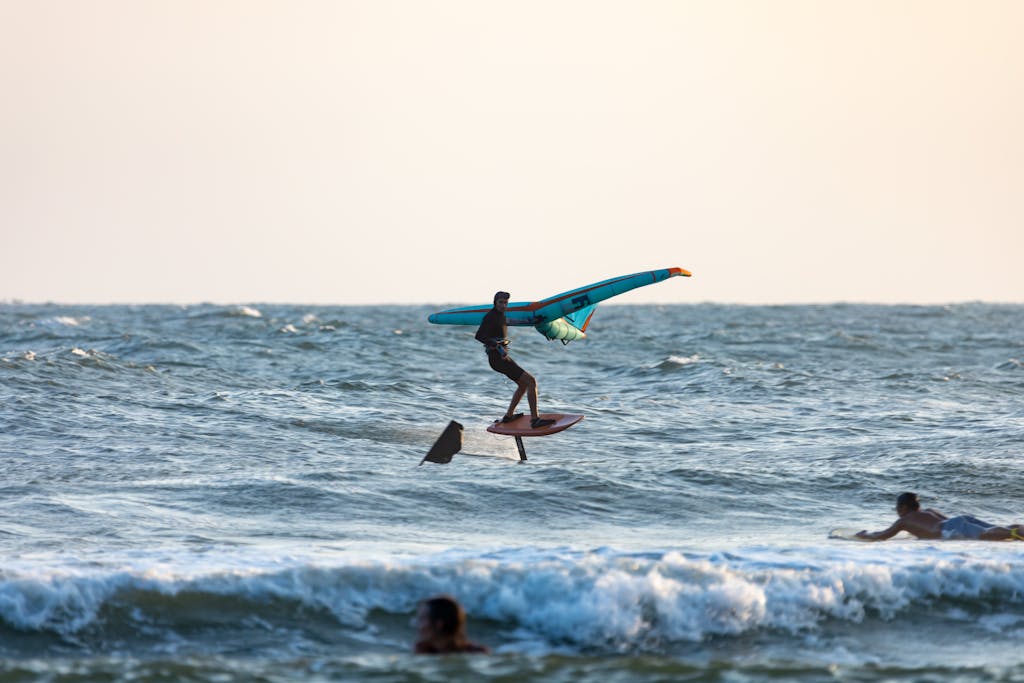 People Wingsurfing and Surfboarding